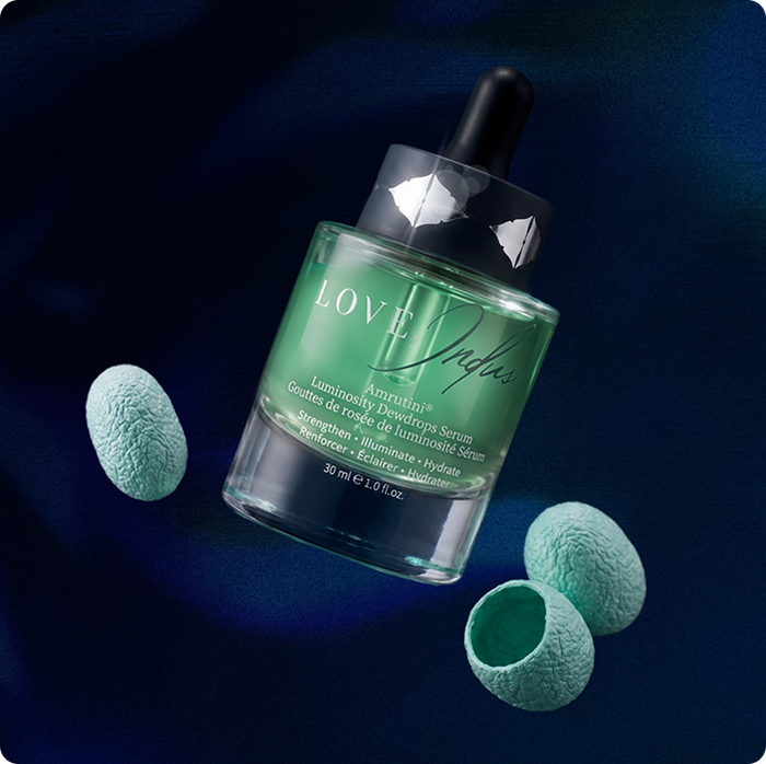 Copper-Crusted Silk Cocoons beside the Amrutini Luminosity Dewdrops Serum